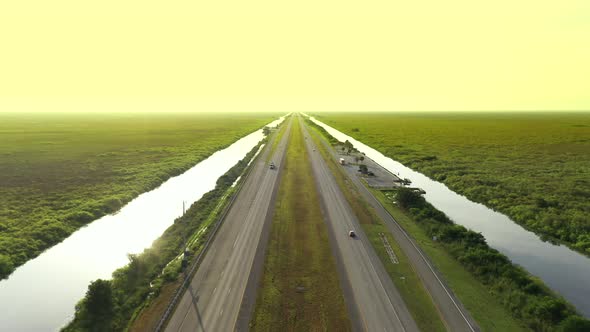 Aerial Video Cars Driving Into A Sunset Yellow Sky 4k