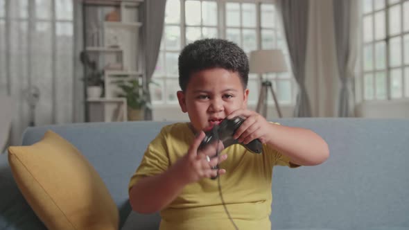 Asian Little Boy Gamer Hands Up Moving While Winning Video Game