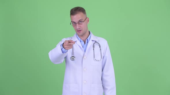 Happy Handsome Man Doctor Pointing at Camera