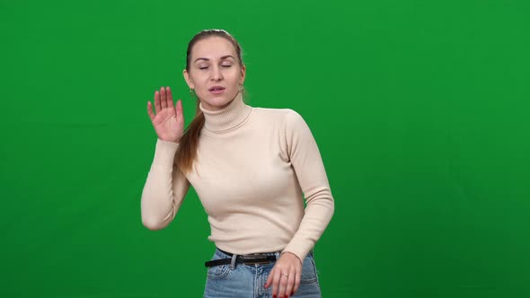 Cute Caucasian Brunette Woman Listening to Something Holding Hand at Ear and Shaking Head Yes