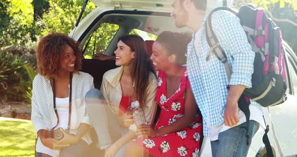 Group of friends taking a selfie from trunk of car