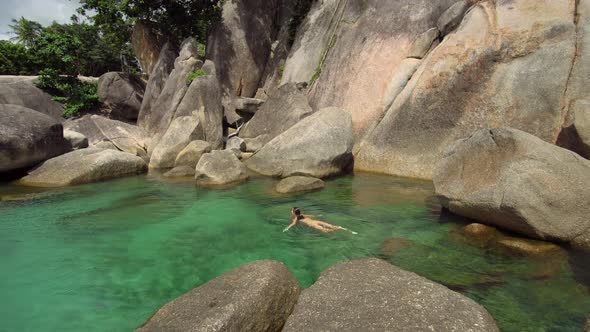 Woman Swimming at Crystal Water Lagoon During Her