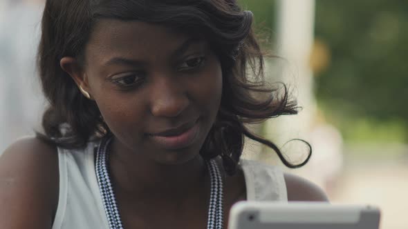 Stylish Black Female Woman Working with Modern Tablet Outdoor in Summer City