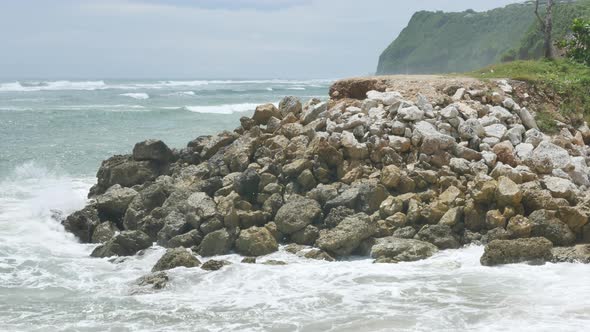 Indian Ocean Waves Hit Rocks Near Pandawa Beach and Green Cliff on the Foreground Bali   Handheld