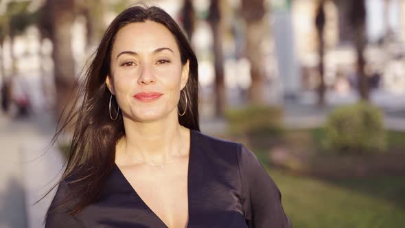 Smiling Hispanic Female Looking at Camera