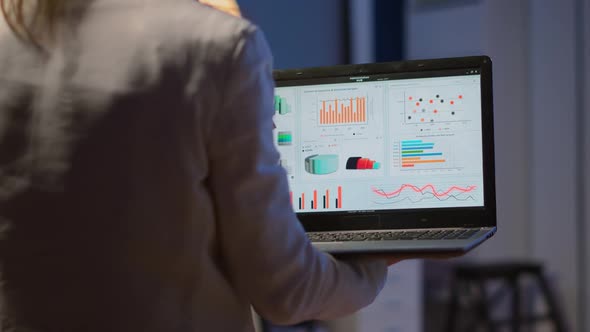 Close Up of Woman Typing on Laptop Standing in Start Up Office