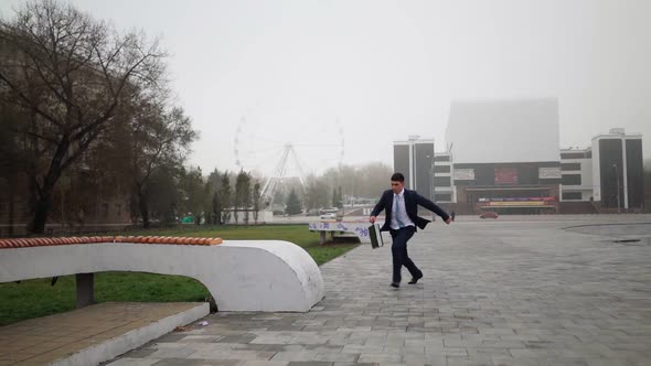 Happy Successful Businessman in Suit and Tie Runs and Jumps for Joy Victory