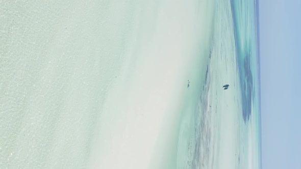 Vertical Video Kitesurfing Near the Shore of Zanzibar Tanzania Aerial View