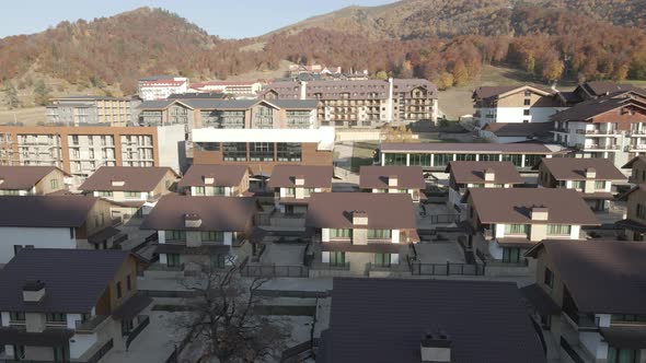 Flying over mountain resort Crystal in Bakuriani. Modern hotel in Georgian mountains