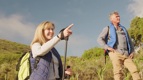 Active senior couple hiking in forest