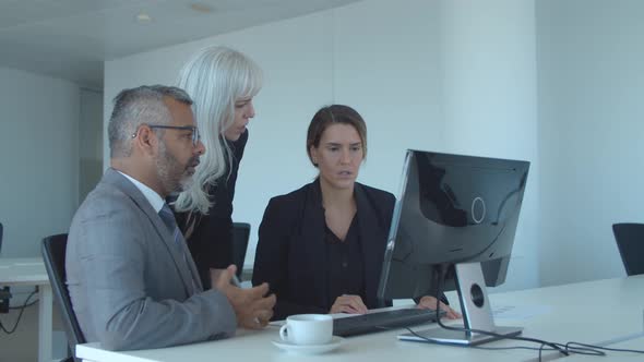 Group of Serious Colleagues Discussing Project