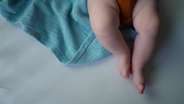 Top View of Baby's Feet in Crib