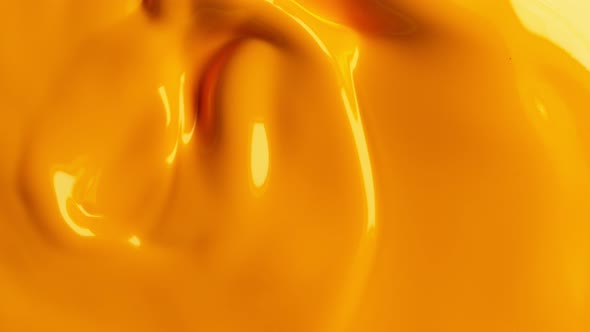 Super Slow Motion Shot of Swirling Yellow Fluid Background at 1000Fps