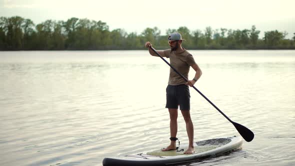 Man Stand Up Paddle Boarding. Warm Summer Beach Vacation Holiday. Travel Paddles Paddleboard. Sup.