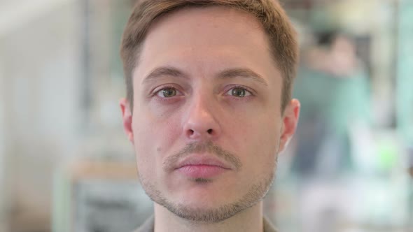 Close Up of Face of Young Man Looking at the Camera