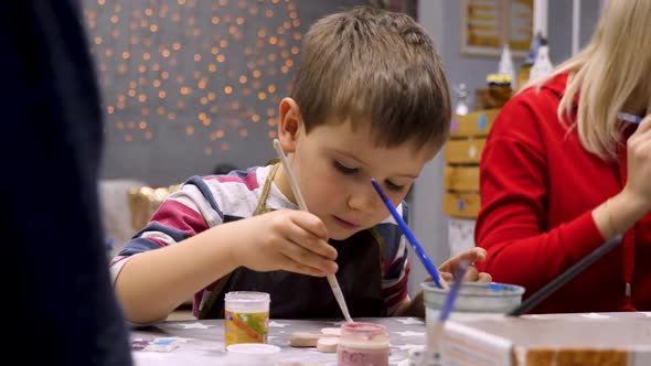 Painting Concept. Paintbrush in Hand of Sitting Preschooler in Art Room. Educational Draw for Create