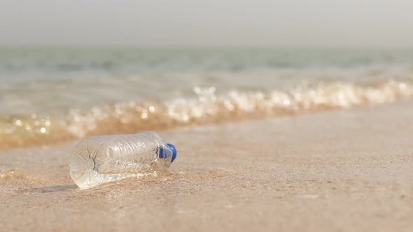 Polyethylene Bag and Plastic Bottle on Sand at Beach  Problem of Pollution