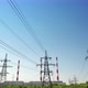 A Power Energy Lines of Highvoltage Transmission Pylons with Heat and Power Plant and Clear Blue Sky - VideoHive Item for Sale