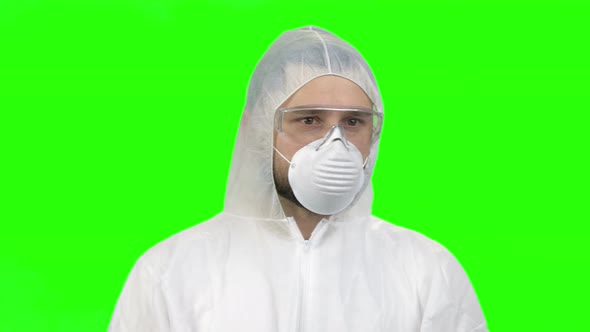 Portrait of Young Man Wearing Protective Suit and Medical Mask for Respiratory Protection