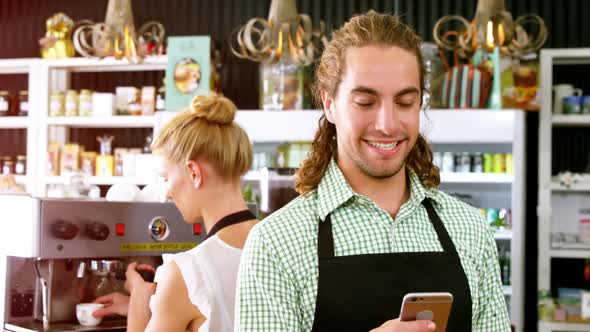 Waiter using mobile phone