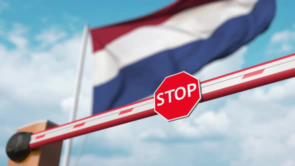 Opening Barrier with Stop Sign Against the Flag of the Netherlands