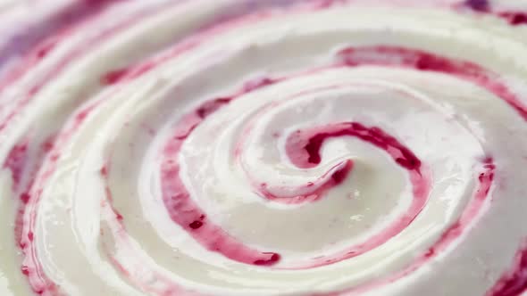 Close up of yogurt with fruit jam, curd cream swirl with berry topping