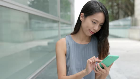 Woman using mobile phone in shopping mall