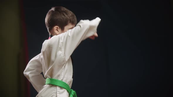 A Little Boy Doing Taekwondo  Showing a Move with His Arm