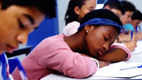 Tired student sleeping in classroom