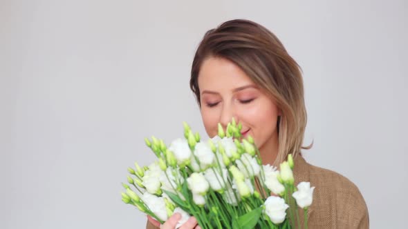 Beautiful woman with white roses on white white background