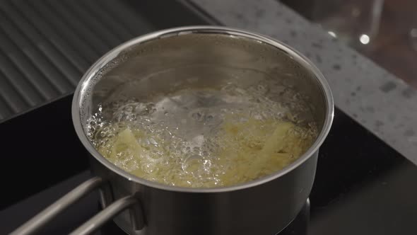 Slow Motion Gimbal Shot of Fettuccine Boiling in Saucepan