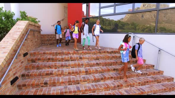 Group of kids getting down from staircase