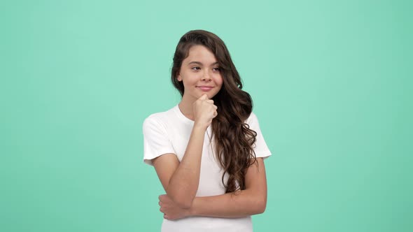 Portrait of Cheerful Pondering Teen Girl Long Curly Hair on Blue Background Ponder