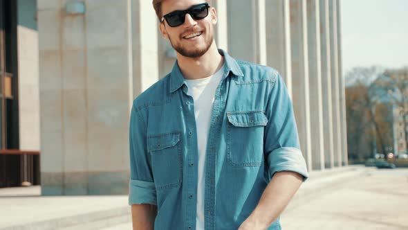 Handsome smiling man in casual clothes outdoors