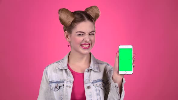 Teenager with a Phone and Paper Notes in His Hands. Pink Background. Slow Motion