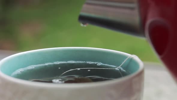 Water pouring into Cup of Tea.