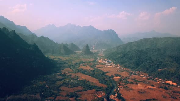 Beautiful Sunrise Over Wild Forest Mountains and River Valley in Morning in Laos . Landscape Aerial