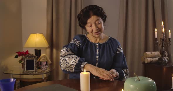 Brunette Caucasian Woman with Brown Eyes Putting Cards on the Table Face Down. Nice Mature Fortune