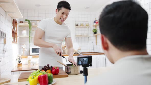 Asia gay couple blogger vlogger and online influencer recording video content on healthy food.