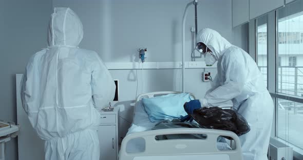 Medical Staff in Protective Suit and Mask Disinfecting Hospital Room During Corona Virus