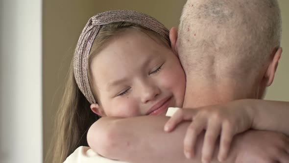 Little Girl Hugs Her Relative with Cancer