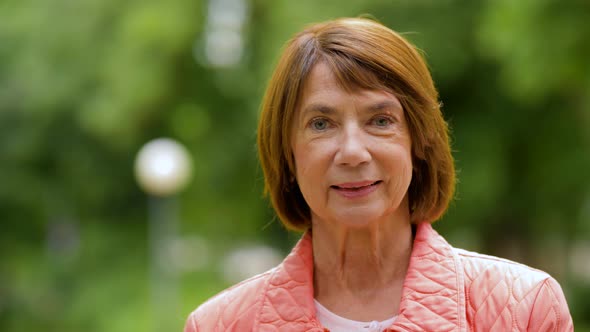 Portrait of Happy Senior Woman at Summer Park