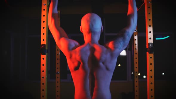 Young Sporty Man Lifting Weights with Barbell