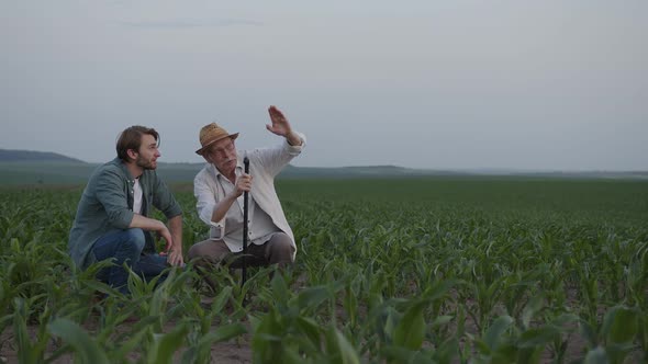 Two Farmers Sit and Discuss Their Fields