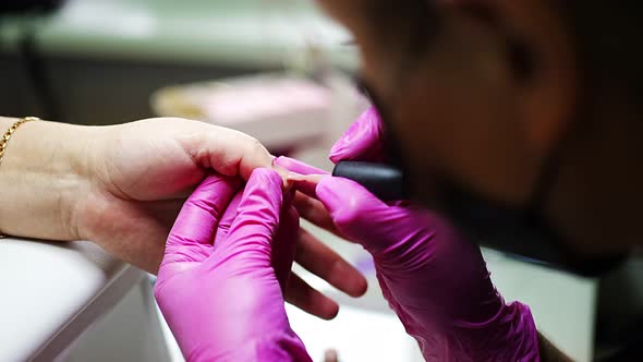 Manicure Artist Making Professional Manicure in Beauty Salon