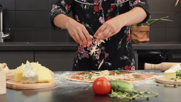 Adding cheese to pizza