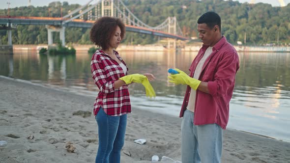 Volunteers Putting on Gloves Prepare to Gather Trash on Beach