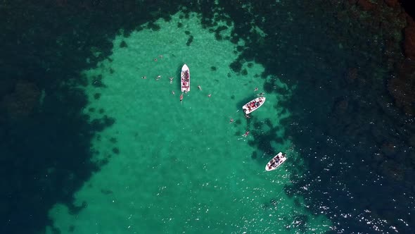 Aerial Photography of Tourist Boats in the Beautiful Clear Turquoise Sea and People Swimming Next to