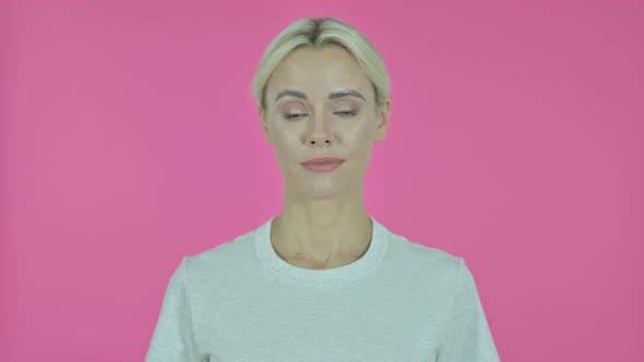 Young Woman Looking at Camera on Pink Background