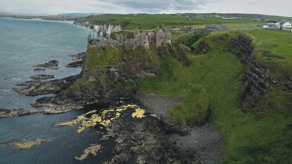 Ireland Medieval Dunluce Castle Aerial View on Cliff in Antrim County
